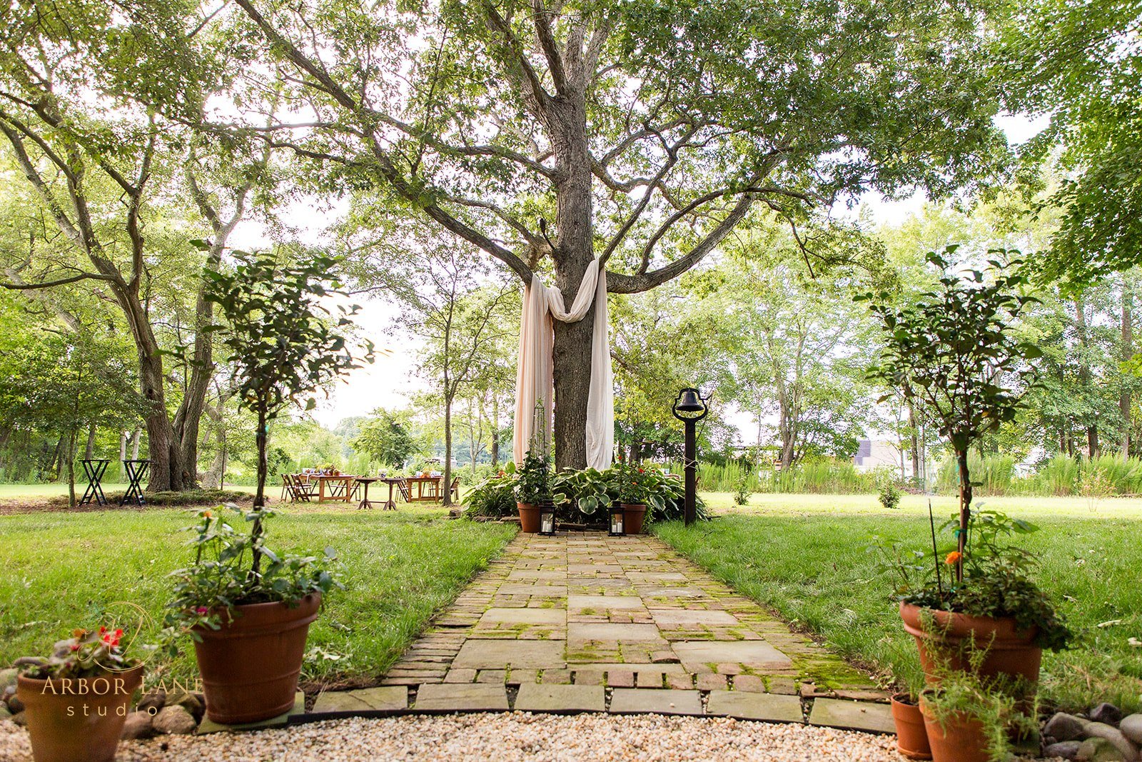 Hobbs & Rose Garden Ceremony Under Oak Tree Garden ceremony pathway beneath an oak tree at Hobbs & Rose Cottage